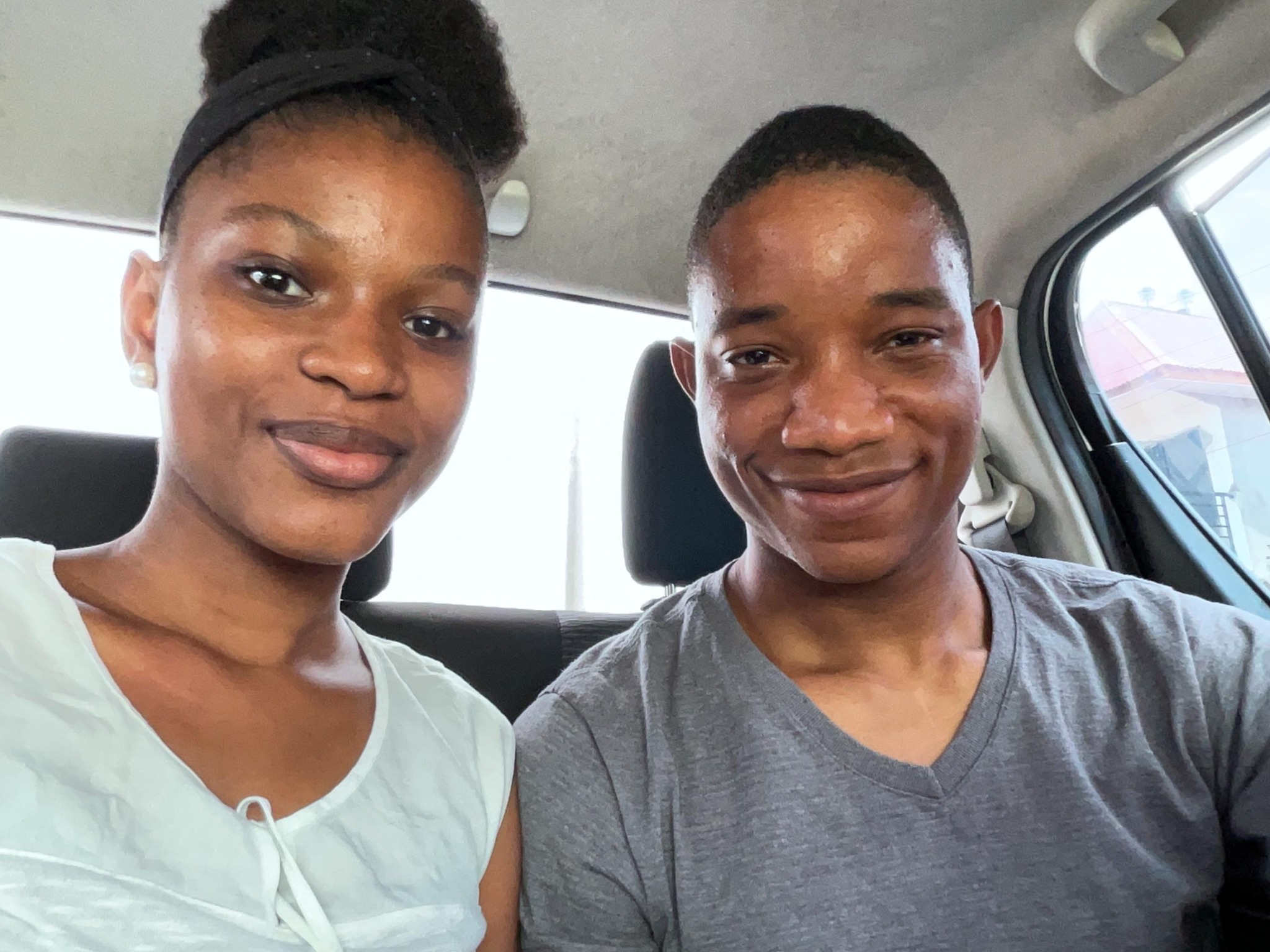Simeon and Benrina smiling in a car